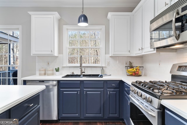 kitchen featuring blue cabinets, sink, white cabinetry, and appliances with stainless steel finishes