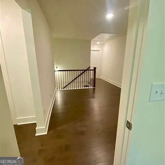 hallway with dark hardwood / wood-style floors