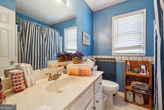 bathroom with toilet, a shower with curtain, tile patterned floors, and vanity