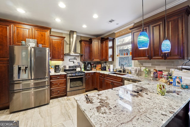 kitchen featuring pendant lighting, appliances with stainless steel finishes, wall chimney range hood, sink, and kitchen peninsula