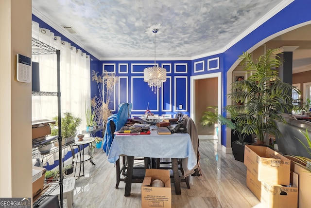 dining space featuring crown molding and a chandelier