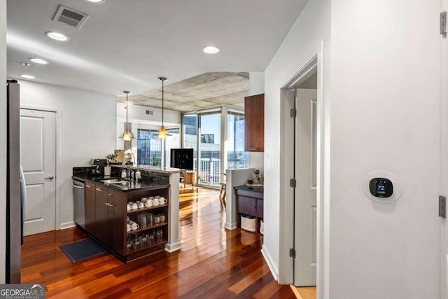 kitchen with sink, stainless steel dishwasher, and dark hardwood / wood-style flooring