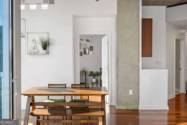 dining space with dark wood-type flooring