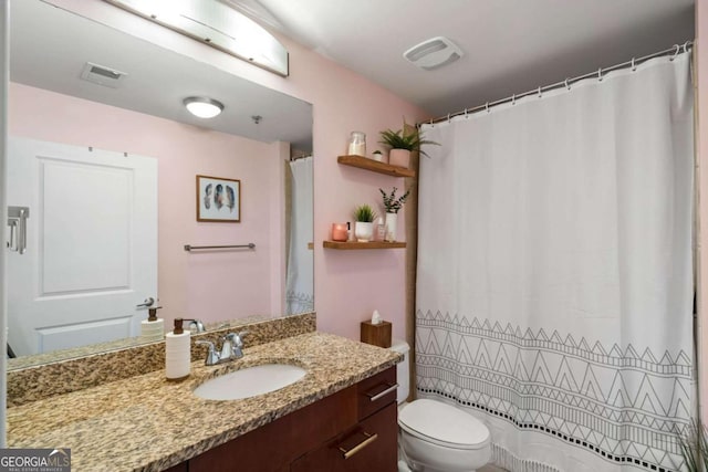 bathroom featuring toilet and vanity