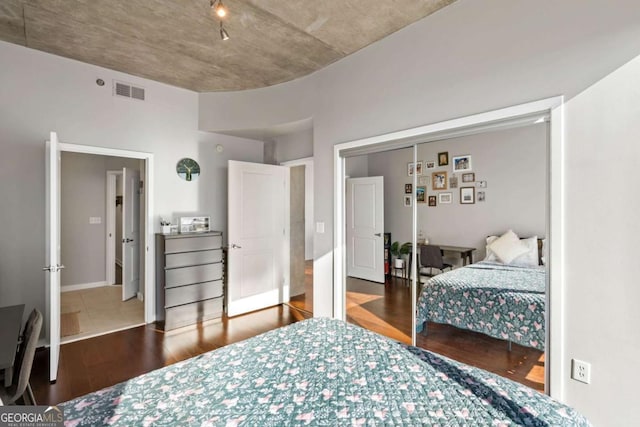 bedroom featuring wood-type flooring and a closet