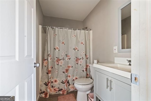 bathroom featuring toilet, a shower with curtain, and vanity