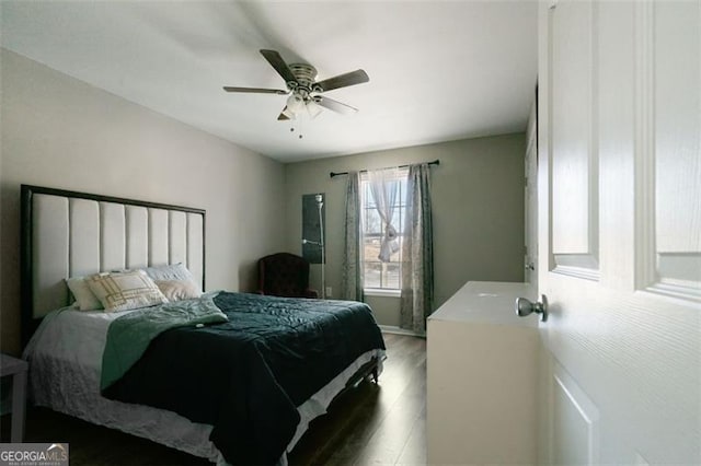 bedroom with ceiling fan and dark wood-type flooring