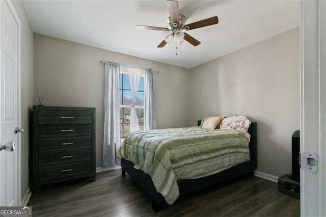 bedroom with ceiling fan and dark hardwood / wood-style flooring