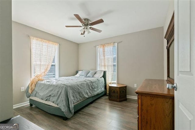 bedroom with ceiling fan and dark hardwood / wood-style flooring