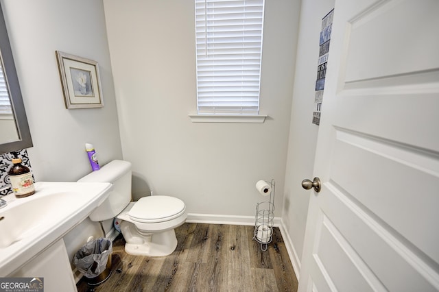 bathroom featuring toilet and wood-type flooring