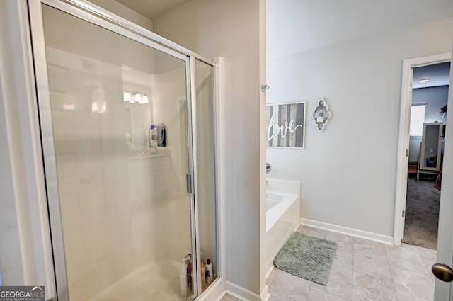 bathroom with tile patterned flooring and independent shower and bath