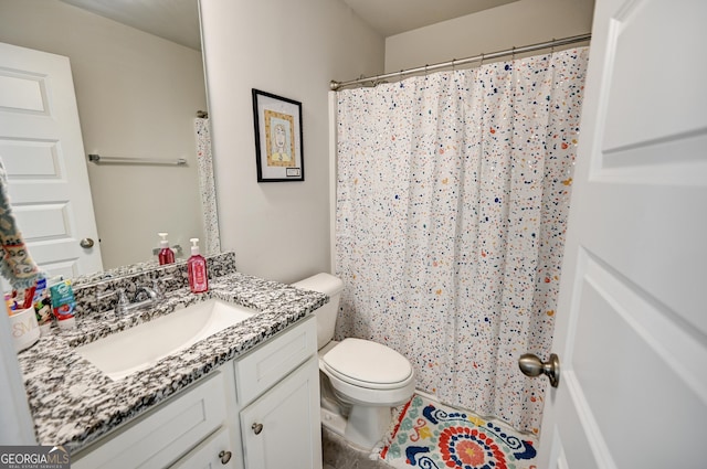 bathroom featuring toilet and vanity