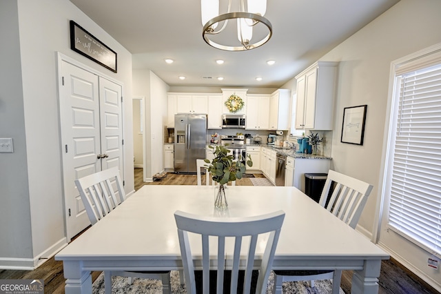 dining room with a chandelier, dark hardwood / wood-style floors, and sink