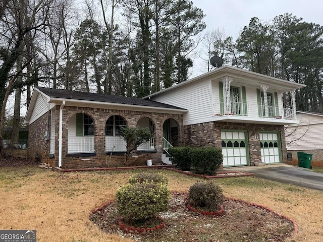 view of front of house with a front lawn, a balcony, covered porch, and a garage