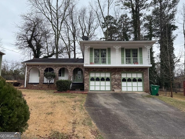 tri-level home featuring a garage and a front lawn