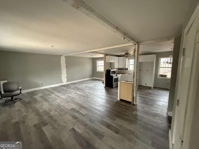 unfurnished living room featuring ceiling fan and dark hardwood / wood-style floors