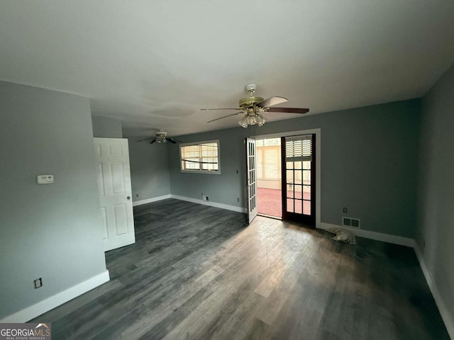 empty room with ceiling fan and dark wood-type flooring