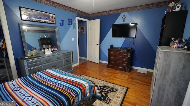 bedroom with wood-type flooring