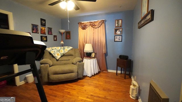 living area featuring ceiling fan and light hardwood / wood-style floors