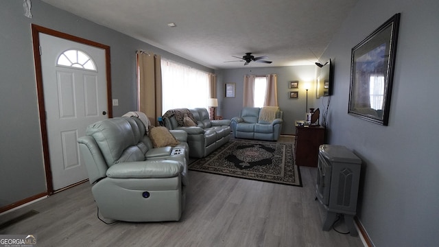 living room featuring ceiling fan and light wood-type flooring