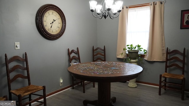 dining area with wood-type flooring and a chandelier