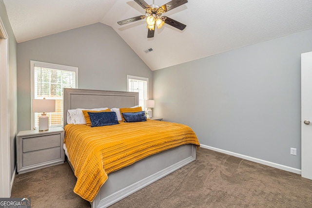 bedroom with ceiling fan, dark carpet, multiple windows, and lofted ceiling