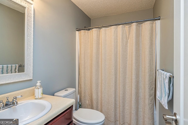 bathroom with a textured ceiling, toilet, a shower with curtain, and vanity