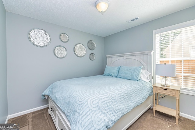 carpeted bedroom featuring a textured ceiling