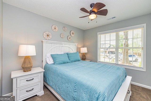 bedroom featuring ceiling fan and dark colored carpet