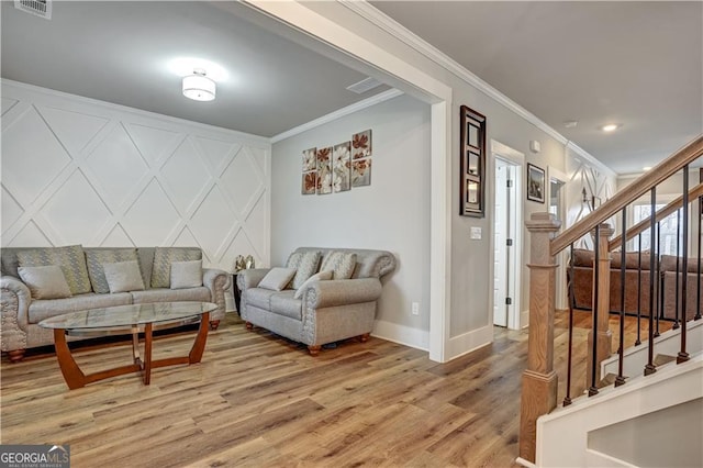 living room with ornamental molding and hardwood / wood-style floors