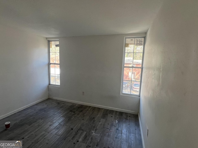 unfurnished room with dark hardwood / wood-style floors