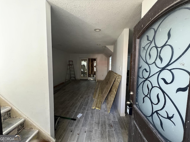 hall with a textured ceiling