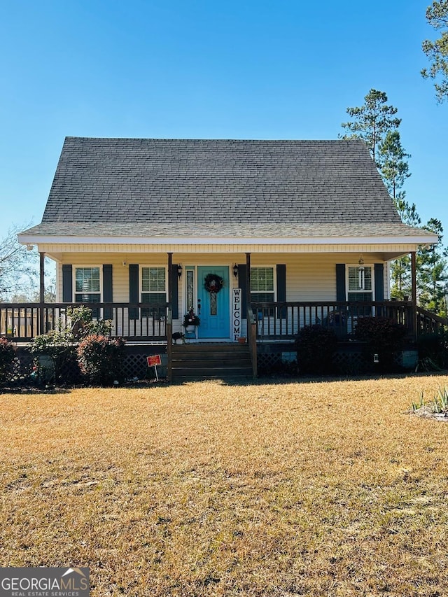 view of front of house with covered porch and a front yard