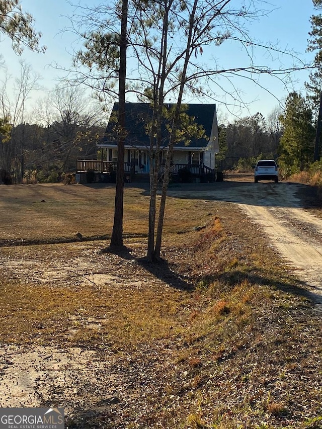 view of front of house with a front lawn and a wooden deck