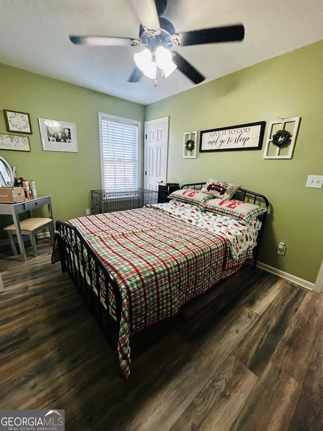 bedroom featuring ceiling fan and dark hardwood / wood-style flooring