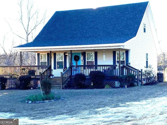 view of front facade with covered porch and central air condition unit