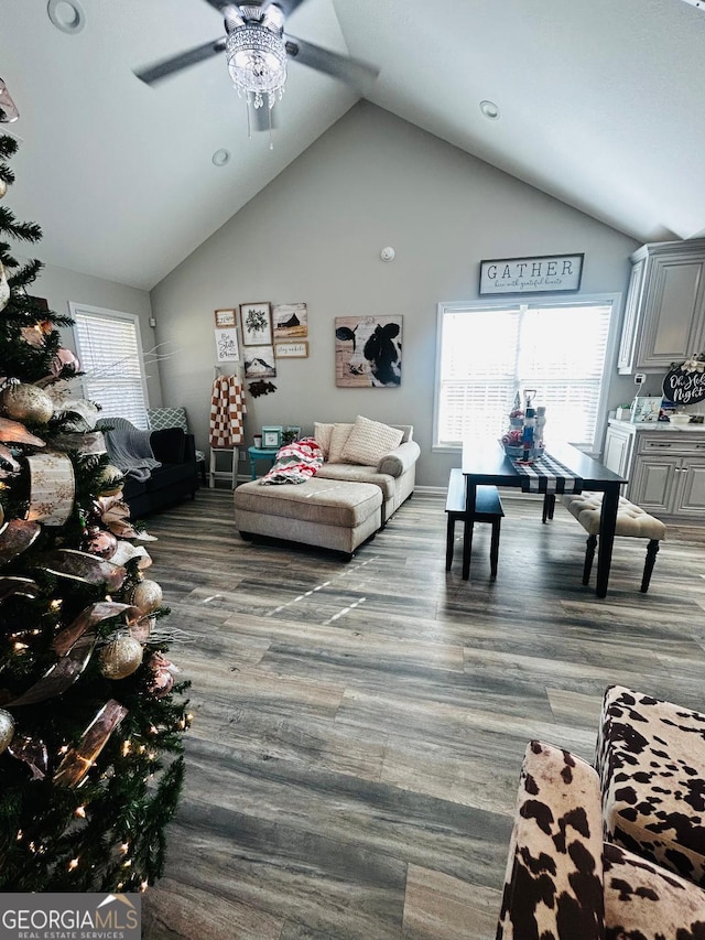 living room with ceiling fan and high vaulted ceiling