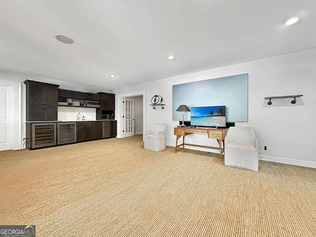 carpeted living room featuring sink and beverage cooler