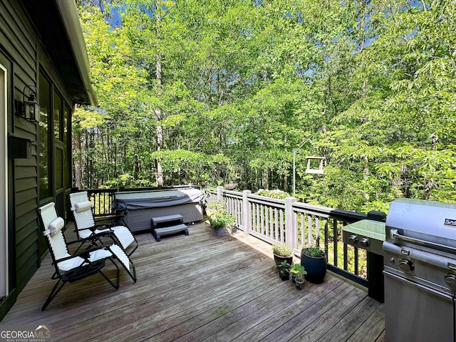 wooden terrace with grilling area and a hot tub