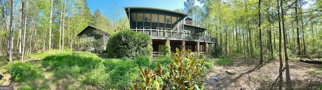 rear view of property with a sunroom