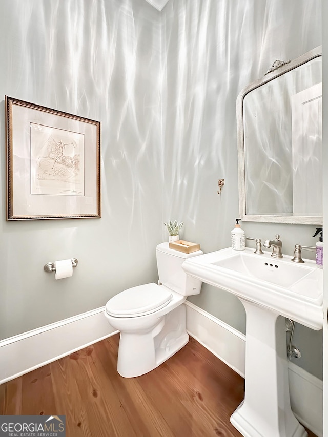 bathroom with toilet and hardwood / wood-style floors