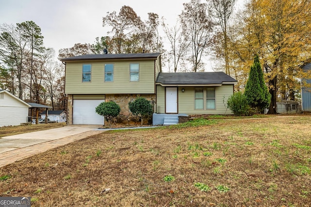 tri-level home with a garage and a front yard