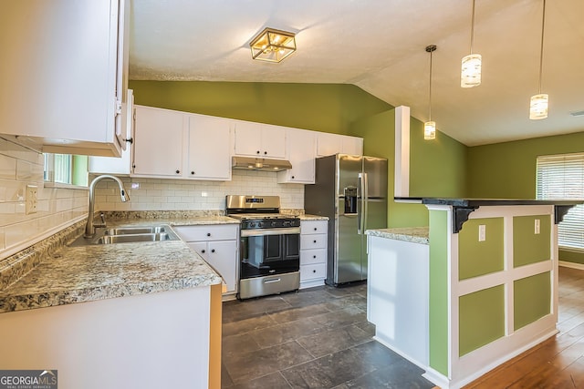 kitchen with lofted ceiling, sink, white cabinetry, hanging light fixtures, and appliances with stainless steel finishes