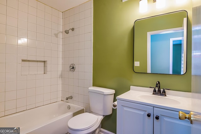 full bathroom with toilet, vanity, and tiled shower / bath combo