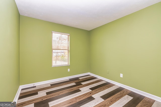 empty room with hardwood / wood-style flooring