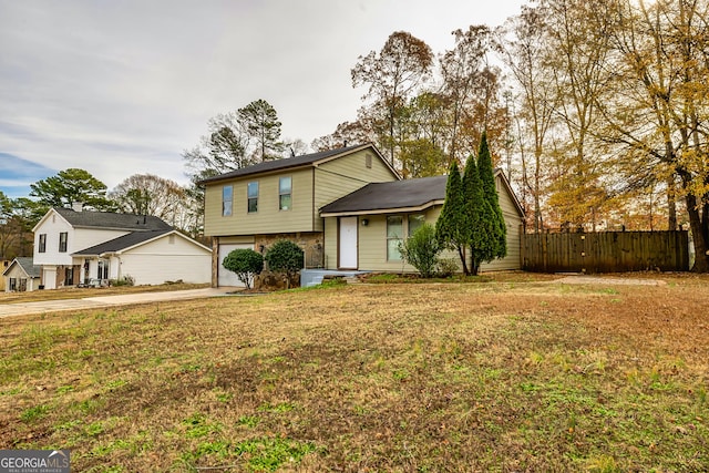 tri-level home with a garage and a front lawn