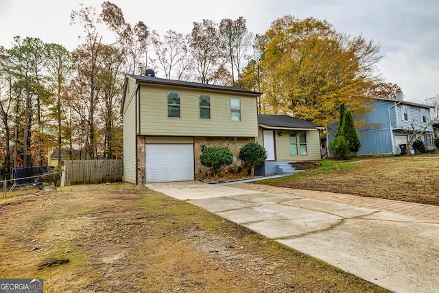 view of front of house with a front yard and a garage