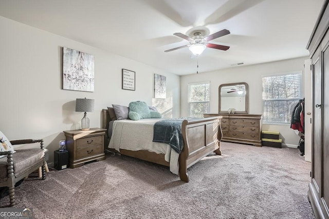 carpeted bedroom with ceiling fan and a closet