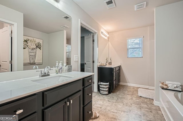 bathroom with vanity and a bath