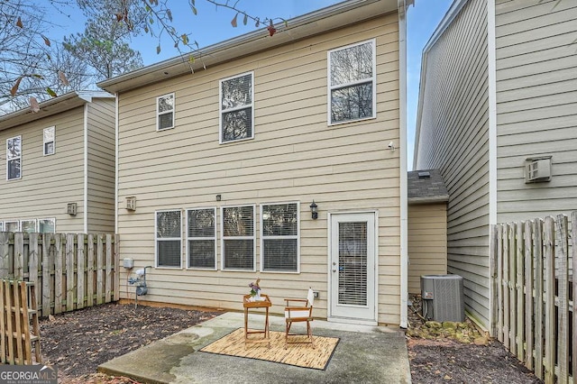 rear view of house featuring cooling unit and a patio area